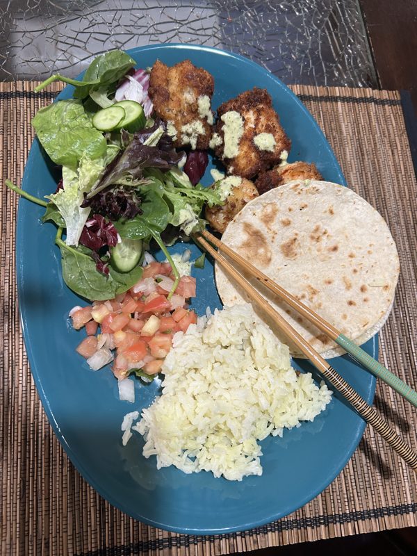 Plated meal with roti, rice, salad, and fried chicken