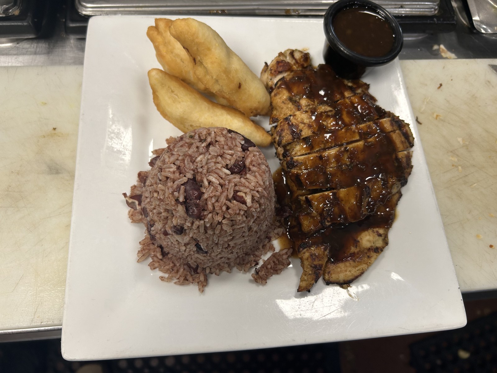 Jerk chicken with rice and peas plated upscale