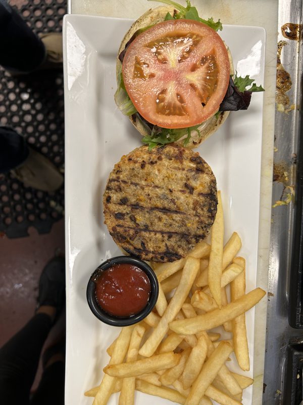 Grilled burger with fries and dipping sauce