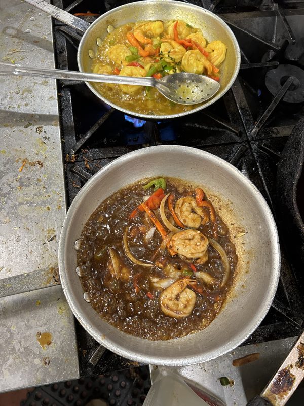 Curry shrimp simmering in pan on stove