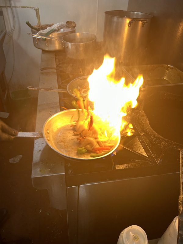 Flames rising in the kitchen during cooking